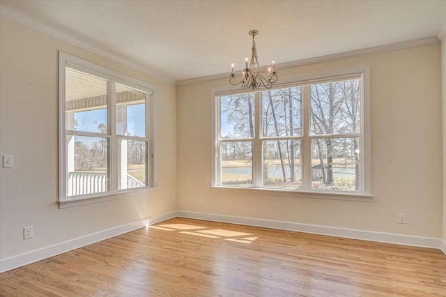 unfurnished dining area featuring ornamental molding, light wood-type flooring, and baseboards