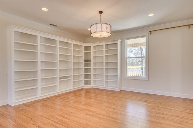 unfurnished room with light wood-type flooring, visible vents, crown molding, and recessed lighting