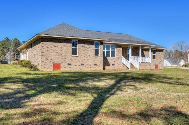 back of property featuring roof with shingles, a porch, crawl space, and a lawn