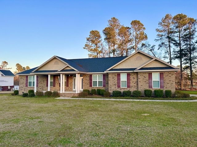 view of front facade with a front lawn and brick siding