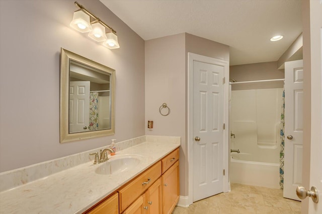 bathroom with shower / tub combo with curtain, vanity, and a textured ceiling