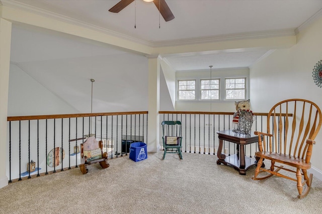 living area featuring ceiling fan, carpet flooring, and crown molding