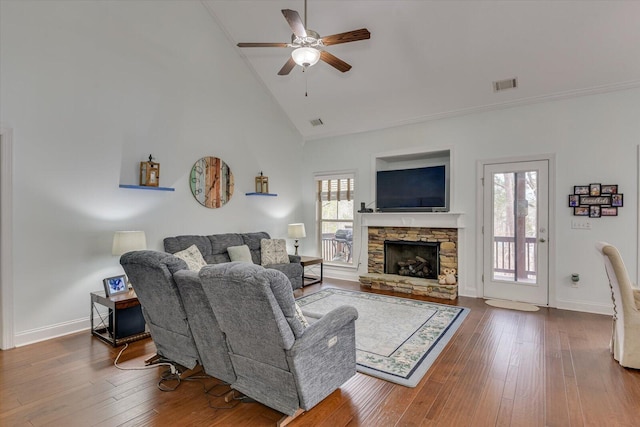 living area featuring baseboards, visible vents, a ceiling fan, wood finished floors, and high vaulted ceiling