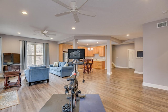 exercise room with light wood-style flooring, visible vents, baseboards, and recessed lighting