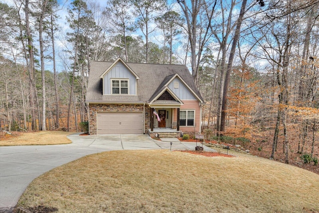 view of front of home featuring driveway, stone siding, an attached garage, board and batten siding, and a front yard