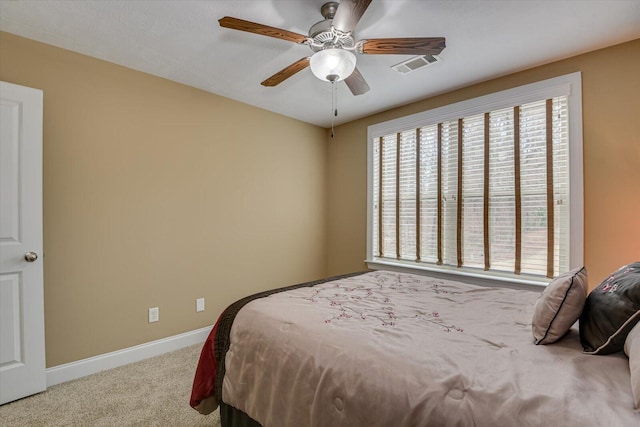 bedroom with carpet floors, visible vents, baseboards, and a ceiling fan