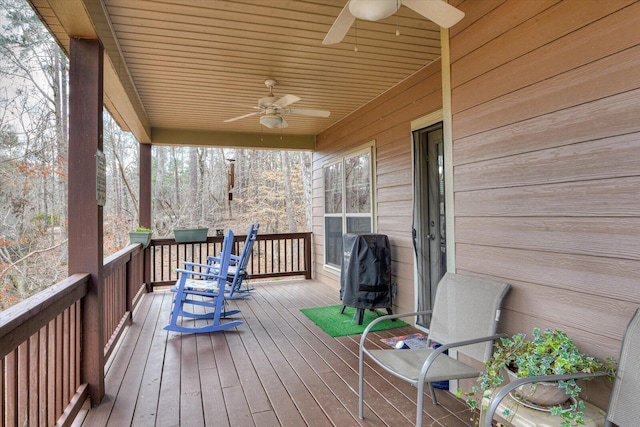 wooden terrace featuring a ceiling fan