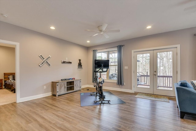 workout room with french doors, recessed lighting, and light wood-style floors