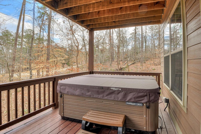 wooden deck featuring a hot tub