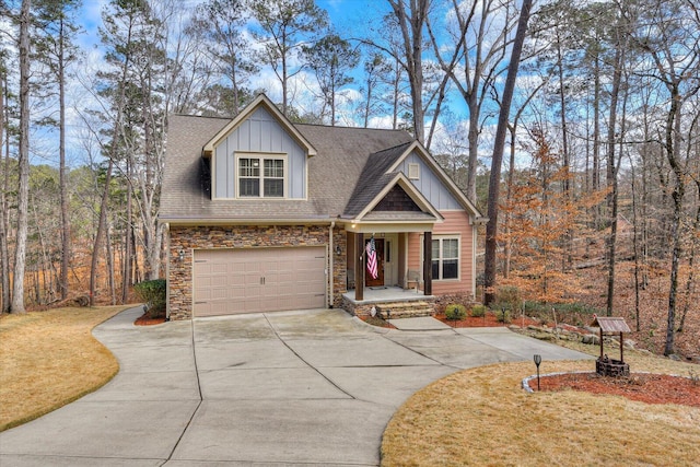 view of front of home with an attached garage, stone siding, concrete driveway, roof with shingles, and board and batten siding