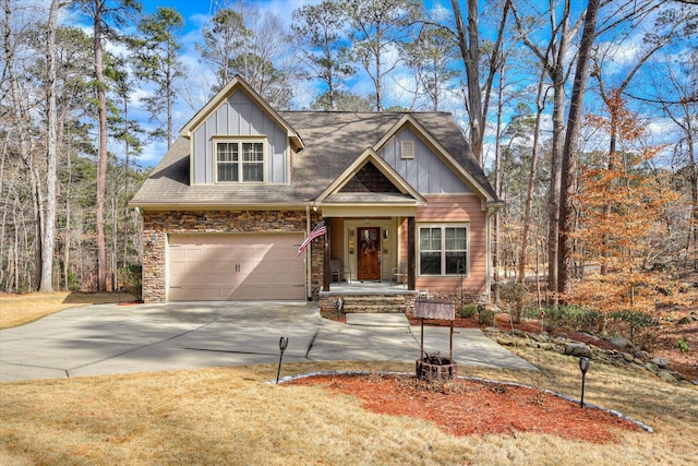 view of front of property featuring a garage, stone siding, board and batten siding, and concrete driveway