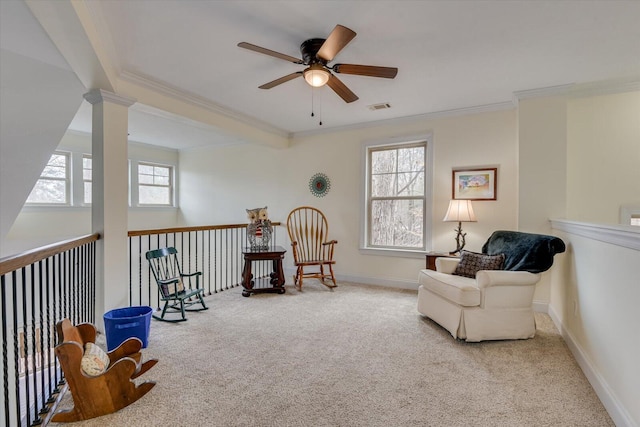 sitting room featuring crown molding, decorative columns, visible vents, light carpet, and baseboards