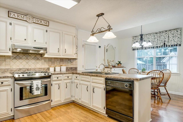 kitchen featuring stainless steel range with gas stovetop, black dishwasher, a sink, under cabinet range hood, and a peninsula