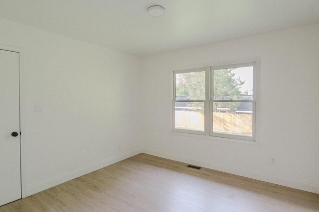 115 W St, Thomson, GA 30824 - unfurnished room featuring light wood-style flooring and baseboards
