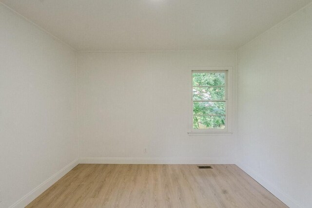 115 W St, Thomson, GA 30824 - empty room with light wood-type flooring and baseboards
