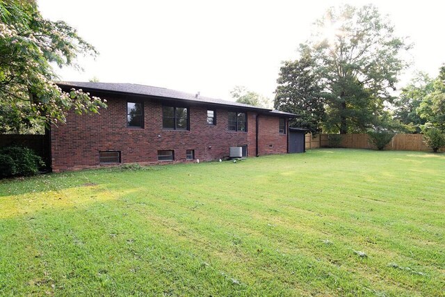 115 W St, Thomson, GA 30824 - back of house with cooling unit and brick siding