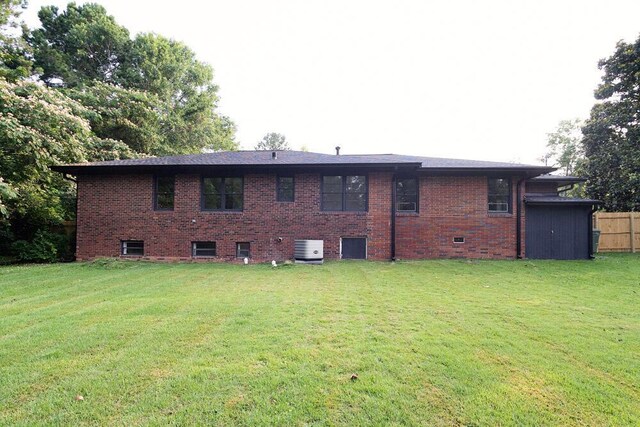 115 W St, Thomson, GA 30824 - rear view of property with cooling unit and brick siding