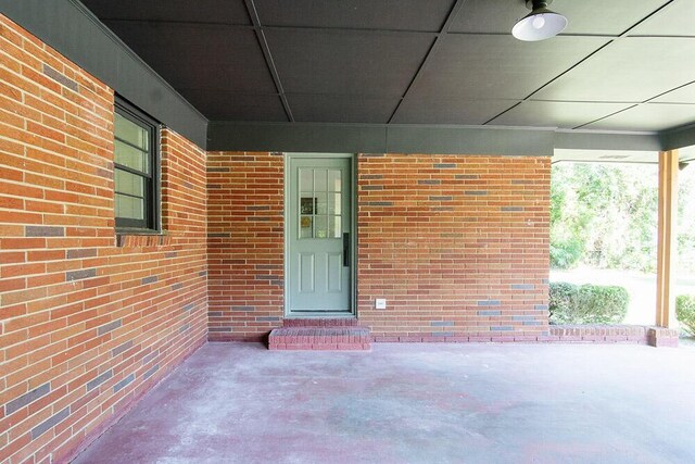 115 W St, Thomson, GA 30824 - doorway to property with brick siding