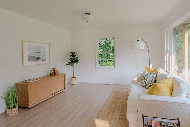 115 W St, Thomson, GA 30824 - living area with light wood-style flooring and baseboards
