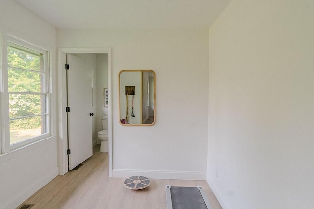 115 W St, Thomson, GA 30824 - corridor featuring light wood-type flooring, baseboards, and healthy amount of natural light