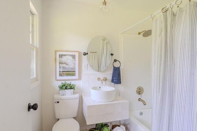 115 W St, Thomson, GA 30824 - full bathroom with toilet, shower / tub combo, a sink, and tile walls