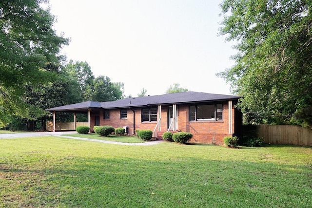 115 W St, Thomson, GA 30824 - single story home with brick siding, an attached carport, and driveway