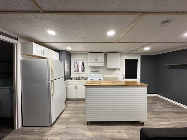 kitchen featuring wood counters, sink, light wood-type flooring, white appliances, and white cabinets