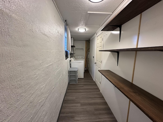 hall with dark hardwood / wood-style flooring, washer / dryer, and a textured ceiling