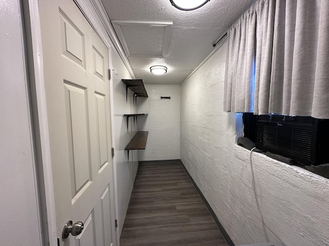 hall featuring cooling unit, dark hardwood / wood-style floors, and a textured ceiling