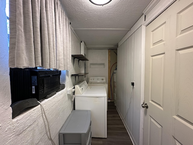 laundry area featuring dark hardwood / wood-style flooring, washer and dryer, and a textured ceiling