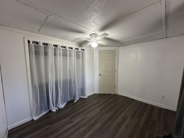 interior space with dark wood-type flooring, ceiling fan, and a textured ceiling