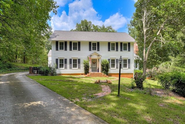 colonial house featuring a front yard