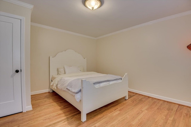 bedroom with light wood-type flooring and ornamental molding