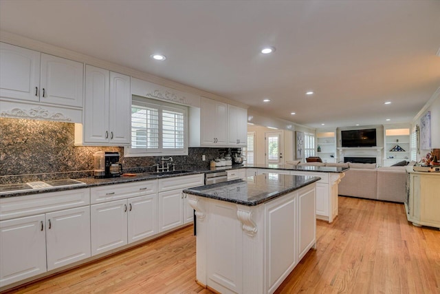 kitchen with white cabinets, sink, and light hardwood / wood-style flooring