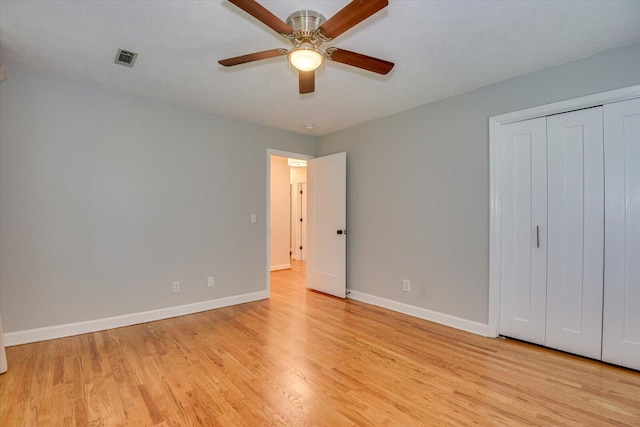 unfurnished bedroom featuring light wood-type flooring, a closet, and ceiling fan