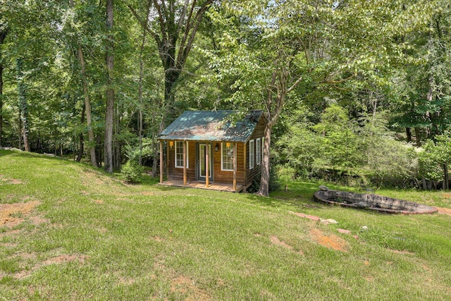 view of outbuilding featuring a lawn