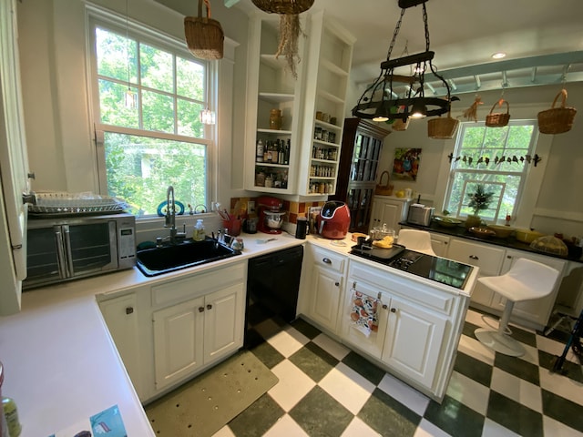 1433 Glenn Ave, Augusta, GA 30904 - kitchen with black appliances, light flooring, white cabinetry, and plenty of natural light