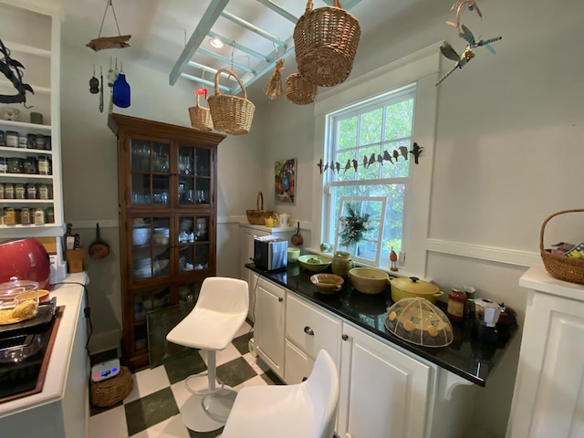 1433 Glenn Ave, Augusta, GA 30904 - kitchen featuring dark countertops, white cabinets, black electric cooktop, and tile patterned floors