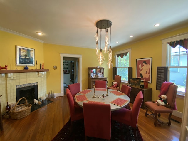 1433 Glenn Ave, Augusta, GA 30904 - dining space with wood finished floors, crown molding, recessed lighting, and a tile fireplace