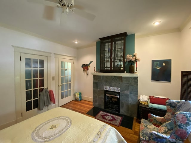 1433 Glenn Ave, Augusta, GA 30904 - bedroom featuring wood finished floors, a tile fireplace, ceiling fan, and crown molding