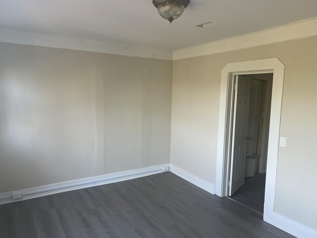 spare room with dark wood-type flooring