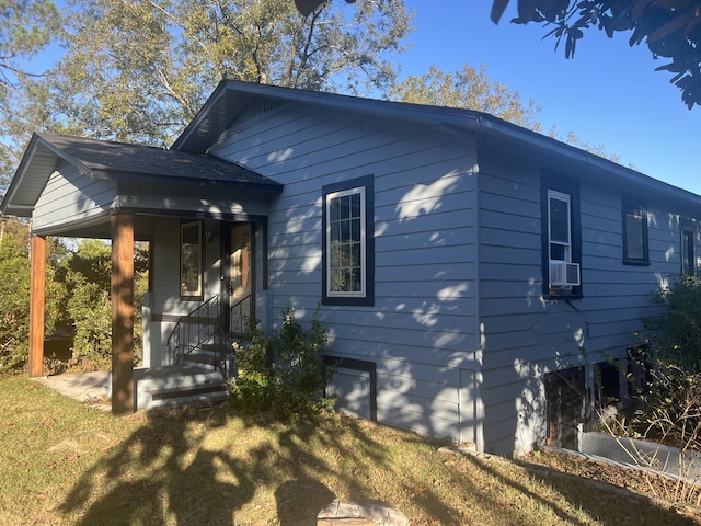 view of front of home featuring a porch, a front lawn, and cooling unit