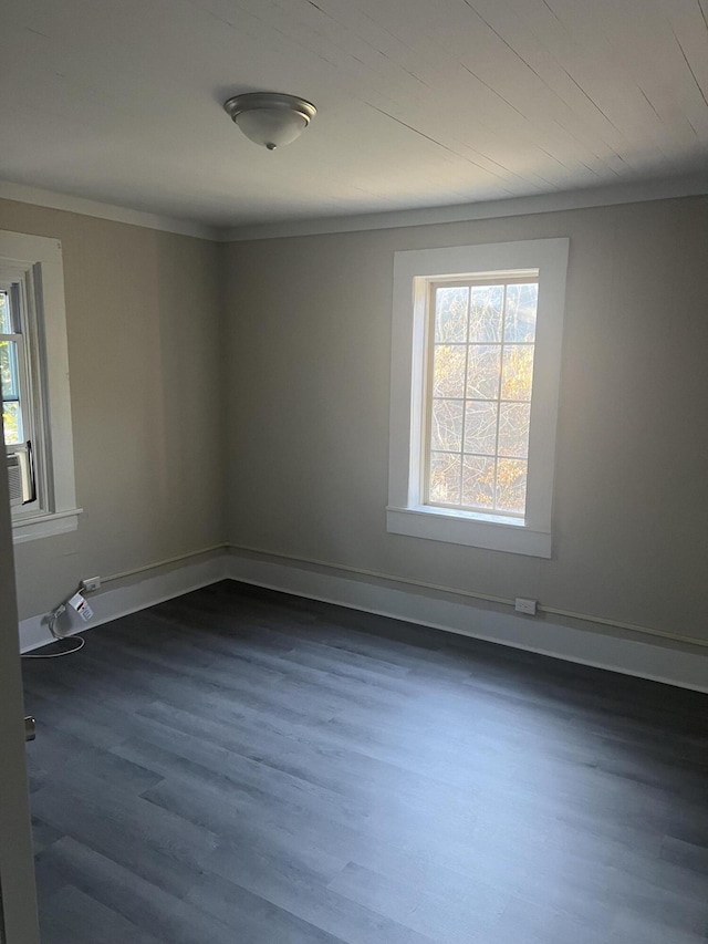 unfurnished room with dark hardwood / wood-style floors and ornamental molding