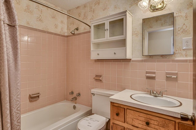 bathroom with wallpapered walls, toilet, a wainscoted wall, shower / bath combination with curtain, and tile walls