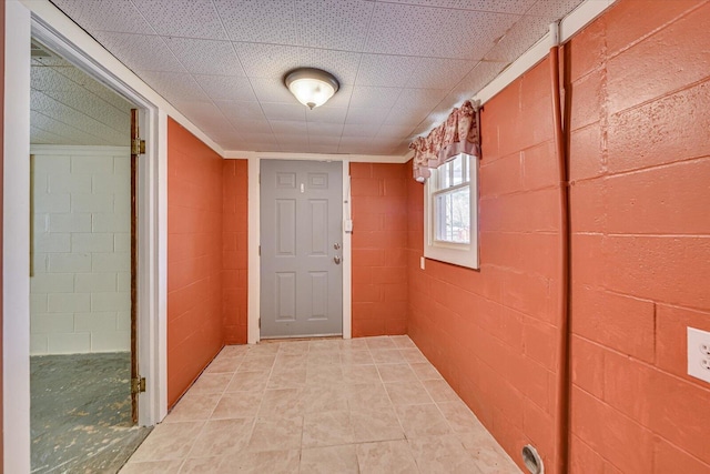 hallway featuring concrete block wall