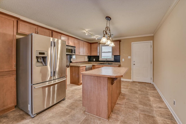 kitchen featuring a textured ceiling, a sink, light countertops, appliances with stainless steel finishes, and a center island