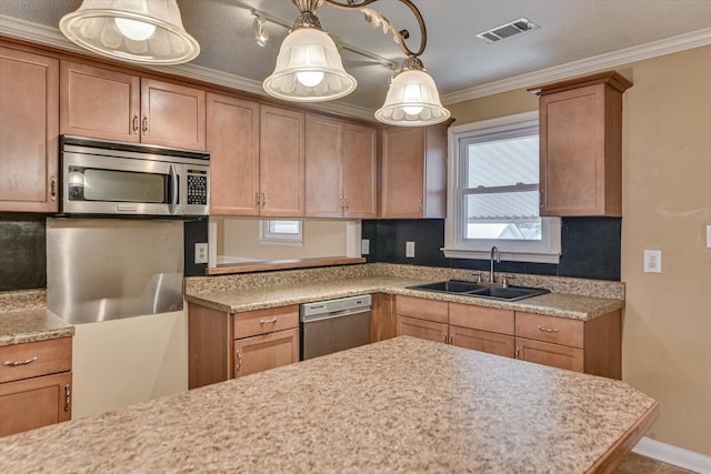 kitchen featuring a sink, visible vents, light countertops, ornamental molding, and appliances with stainless steel finishes