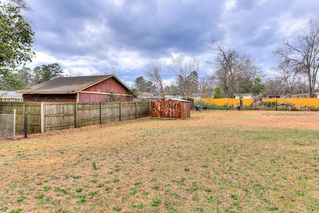 view of yard featuring an outbuilding and fence private yard