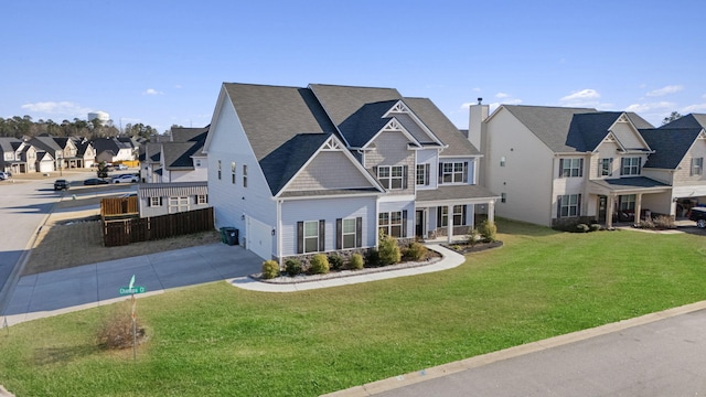 view of front of house with an attached garage, a front yard, fence, a residential view, and driveway