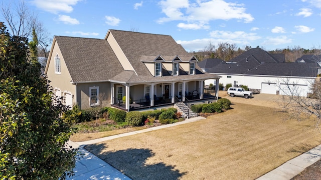 back of property featuring a garage, roof with shingles, covered porch, a yard, and stucco siding